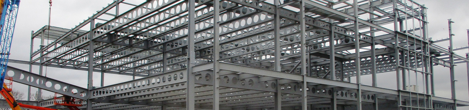 Steel beams with holes in for cables and pipes